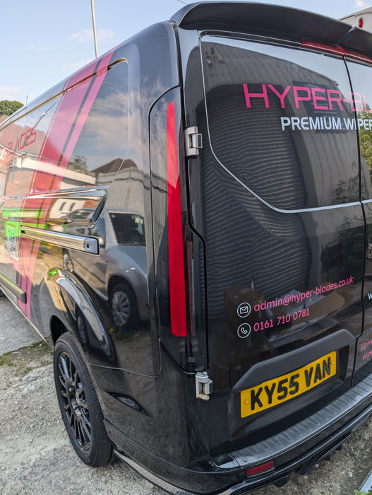 Red LED tail light illuminated on a black Ford Transit Custom