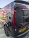 Red LED tail light illuminated on a black Ford Transit Custom