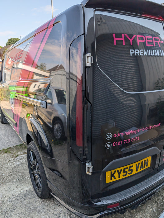Smoked LED rear light unit fitted to a black Ford Transit Custom