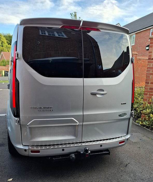 Rear view of a silver Ford Transit Custom with smoked LED rear light units fitted