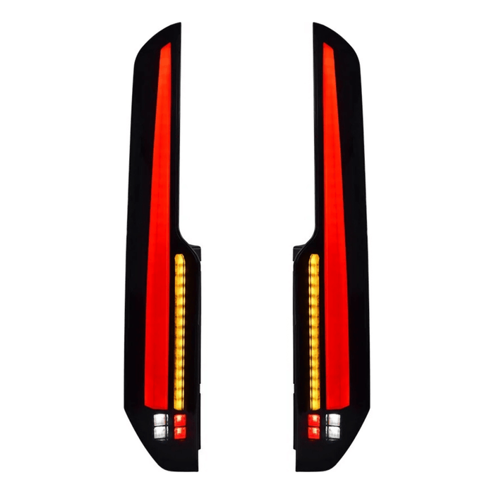 Pair of smoked Ford Transit Custom rear light units showing LED tail lights, amber sequential indicators and lower lamps