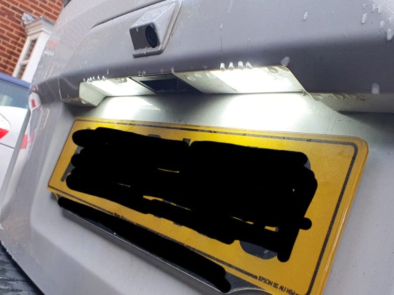 Two white LED number plate lights installed above a rear registration plate