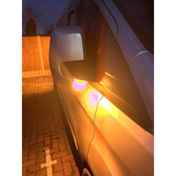 Amber under-mirror LED indicator illuminated on a Ford Transit Custom 2012-2023 side mirror at dusk